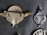 some old metal items are displayed on a black surface