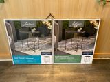 two boxes of outdoor furniture sitting on the floor next to each other