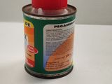 a bottle of paint sitting on a table next to a can of paint
