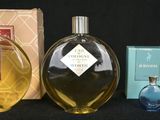 a bottle of cologne next to a box of perfume