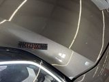 a sticker on the hood of a silver car