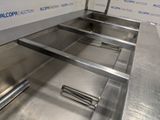 a metal conveyor belt in the middle of a room