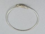 silver ring with a lizard head on top of it on a white surface