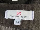 the label on the jacket shows the name of the designer