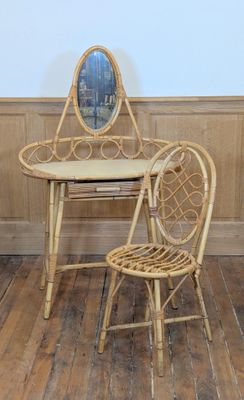 a chair and a table with a mirror on the wall