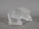 une figurine en verre représentant un taureau, posée sur un socle