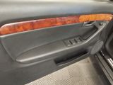 the interior of a car with the door open showing the wood trim