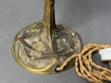 an image of a brass candle holder with a rope wrapped around it