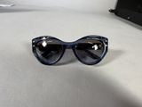 a pair of sunglasses sitting on a table next to a laptop