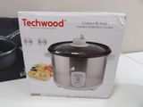 boxed box of a crock pot sitting on a table next to a pot