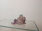 a glass table with a frog on top of it