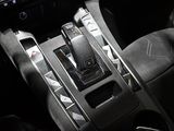 the interior of a car with a steering wheel and dashboard controls