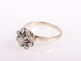 an 18k gold ring with a cluster of diamonds