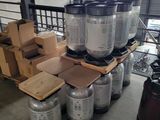 several kegs of beer are stacked on a pallet in a warehouse
