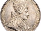 an old silver coin with a portrait of a man wearing a crown