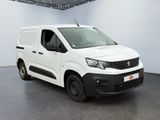 the white van is parked in a large room with a black floor
