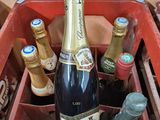 des bouteilles de vin dans une caisse rouge munie d'une poignée noire