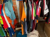 a lot of clothes hanging on a rack in a room