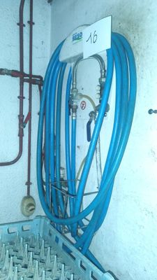 a blue hose that is attached to a wall