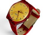 une montre-bracelet rouge avec un cadran jaune sur fond blanc
