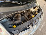 the engine of a car with its hood open on the street