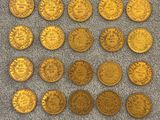 a pile of gold coins sitting on top of a carpet