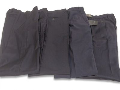 three men ' s pants are lined up on a white surface