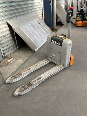 a forklift that is sitting in front of a garage door