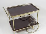 an image of a brass and glass bar cart on wheels