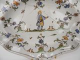 a plate with a picture of a man holding a kite