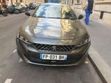 the car is parked on the side of the street in the city