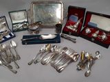 a table with silverware and other silverware on it