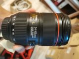 a person holding a camera lens in their hand