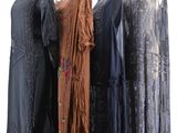 three dresses on a mannequin stand on a white background