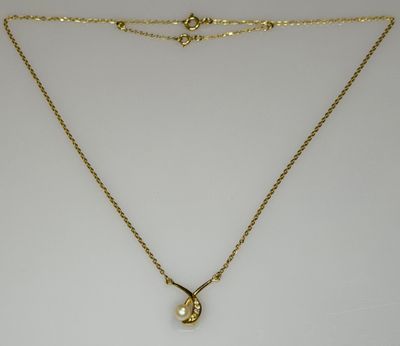 a gold necklace with a pearl pendant on a gold chain