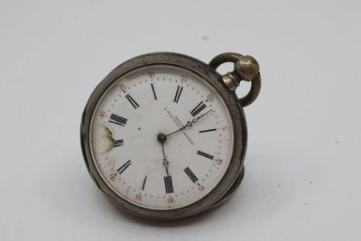 a silver pocket watch with roman numerals on the face