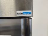a stainless steel refrigerator with a microwave on top of it
