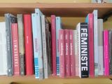 a book shelf with many books on top of it