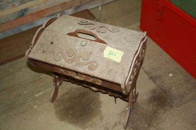 an old suitcase sitting on a small stool in a room