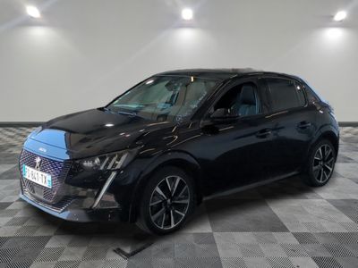 the black car is parked on a checkered floor in the garage