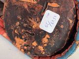 a baseball mitt with a tag on it sitting on a table
