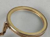 a magnifying glass with a gold handle on a table