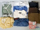 many different types of clothing laid out on a table