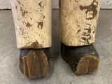 a close up view of a pair of wooden feet