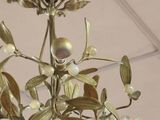 a chandelier with a bunch of flowers hanging from the ceiling