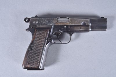 an old gun is laying on a table with a white background