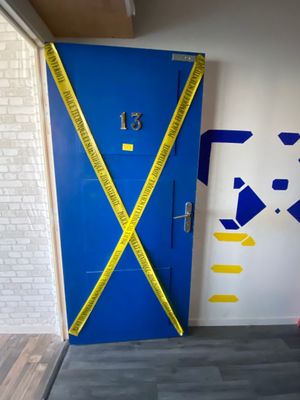a blue door with yellow tape taped around it