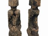 pair of stone statues with umbrellas on a stand on a white background