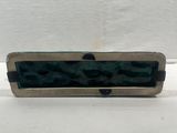 a close up of a metal object on a white surface