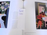 an open book with a picture of a vase of flowers and a picture of a vase of flowers on a table